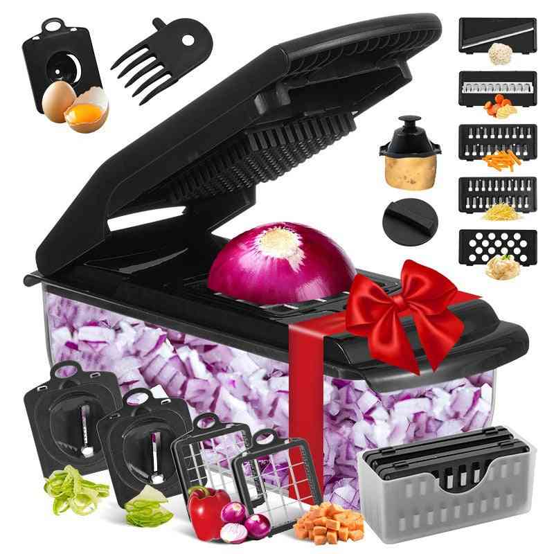 Black kitchen chopper with various attachments and chopped vegetables on a white background