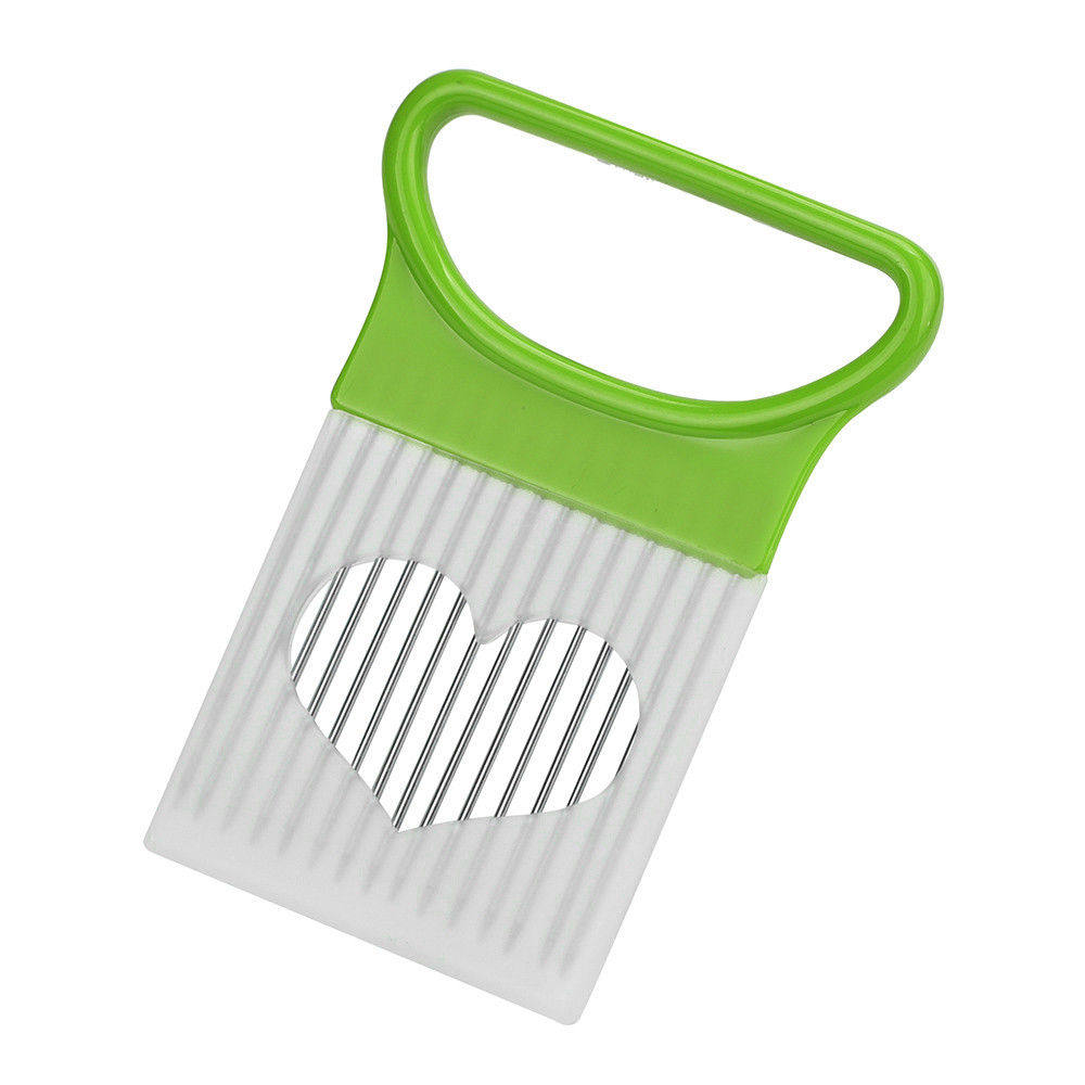 Green-handled vegetable slicer with white blade on a white background