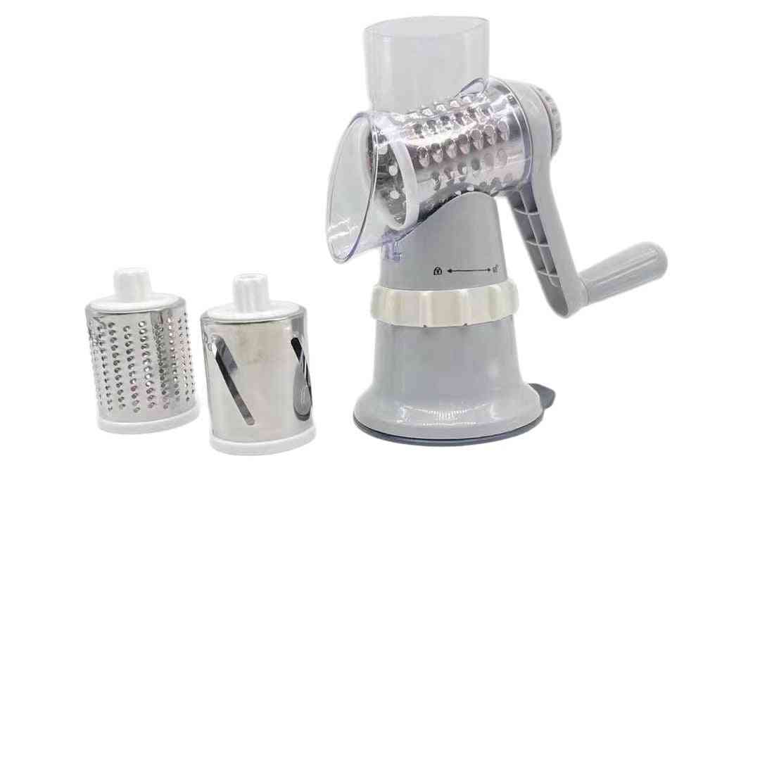 Manual rotary cheese grater with two additional grating drums on a white background