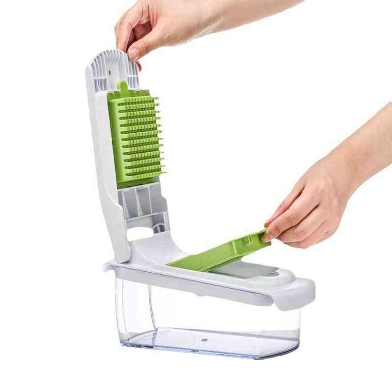 Vegetable chopper with green and white components on a white background